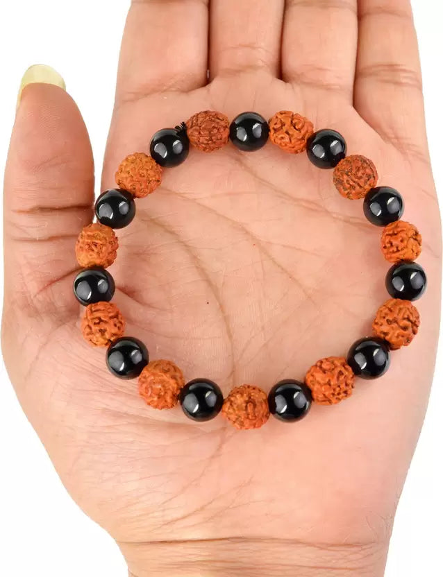 hand holding a Rudraksha Braclet