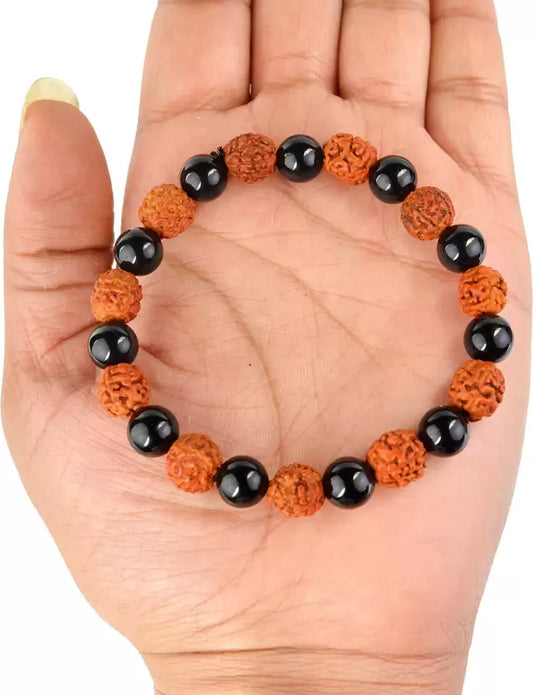 hand holding a Rudraksha Braclet